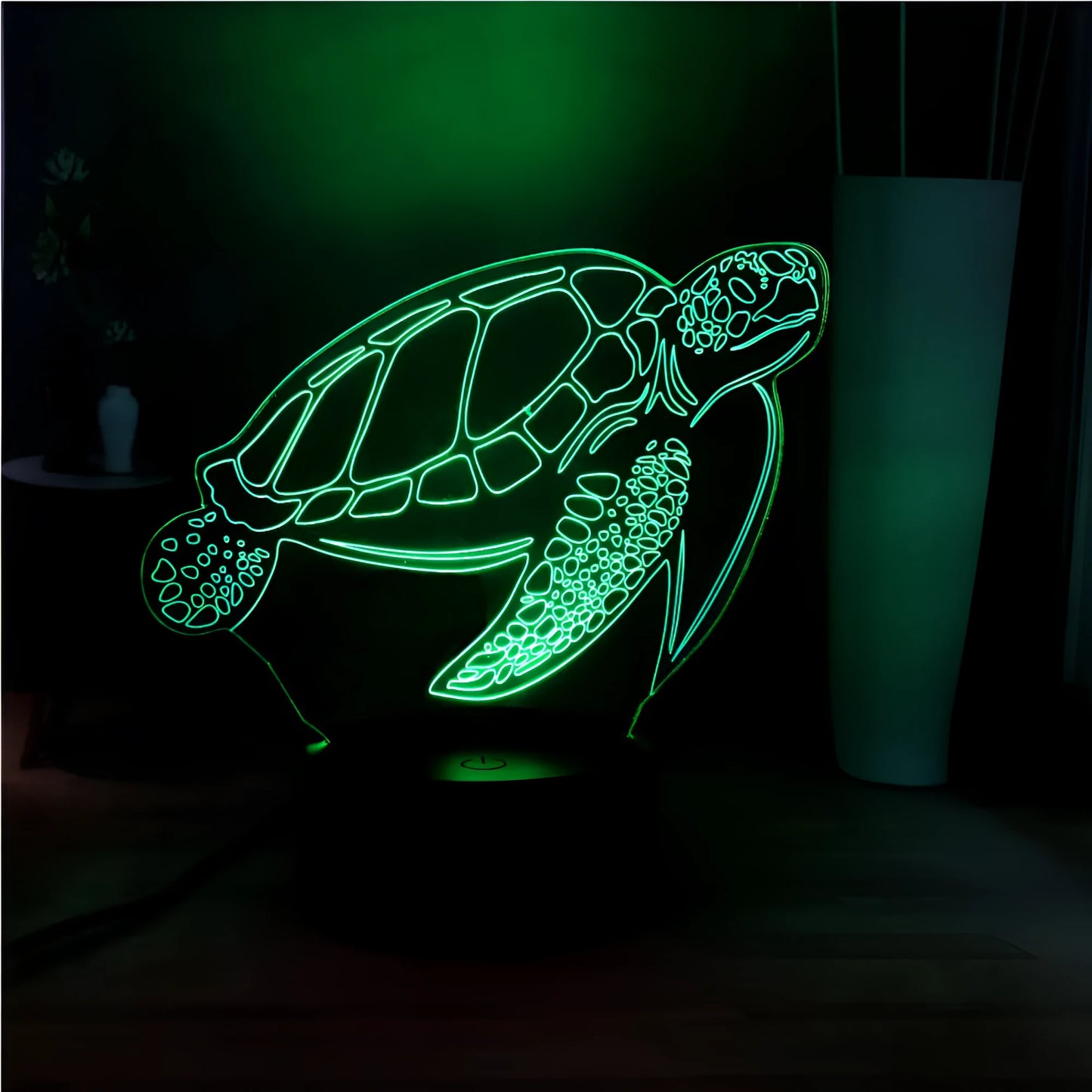 3D acrylic turtle-shaped LED night light showing one of its 16 colour options on a bedroom shelf.