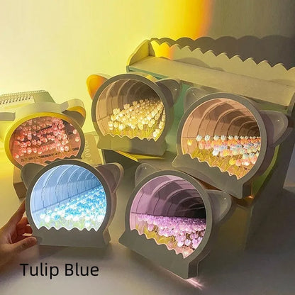 Handmade DIY cat head shaped night lamp with colourful tulip flower sea decoration on a table.