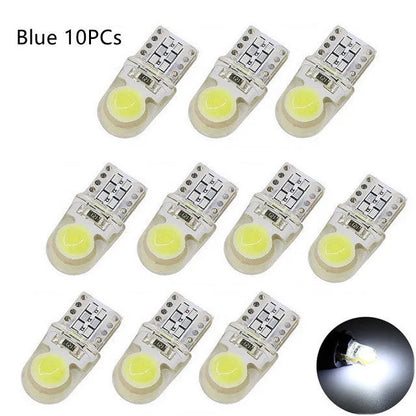 Pack of ten T10 wedge base LED car bulbs with COB chips in various colours on a white background