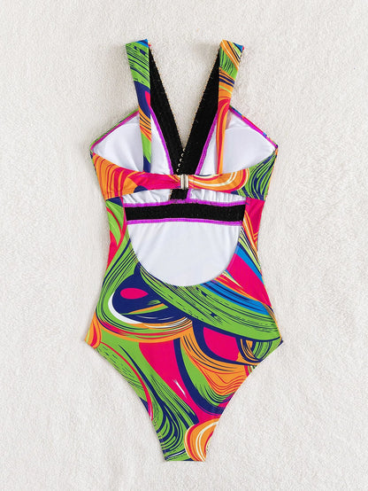 Women's deep V neck one-piece swimsuit with spaghetti straps in printed polyester fabric.