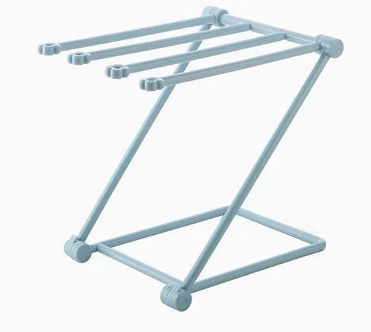 Foldable plastic dishcloth shelf organiser in light blue mounted on a wall.