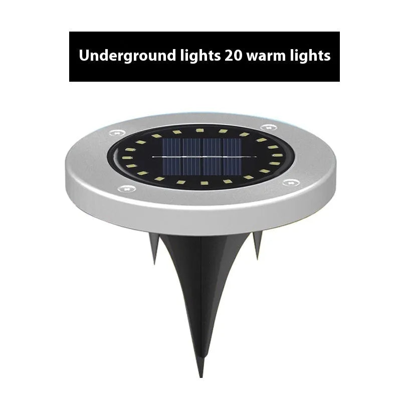 Stainless steel solar garden ground lamp installed in a lawn.