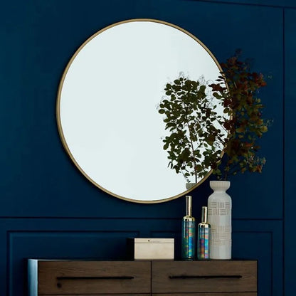 Round metal-framed wall mirror in black, white, or gold for bathroom.
