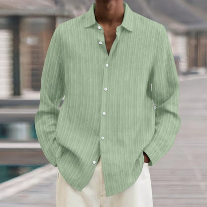Man wearing a loose fit plain colour striped long sleeve cardigan shirt.