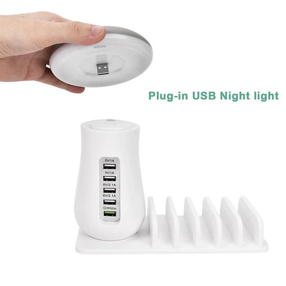 White mushroom-shaped USB charging dock station with 5 ports and an illuminated LED night light on a wooden desk.