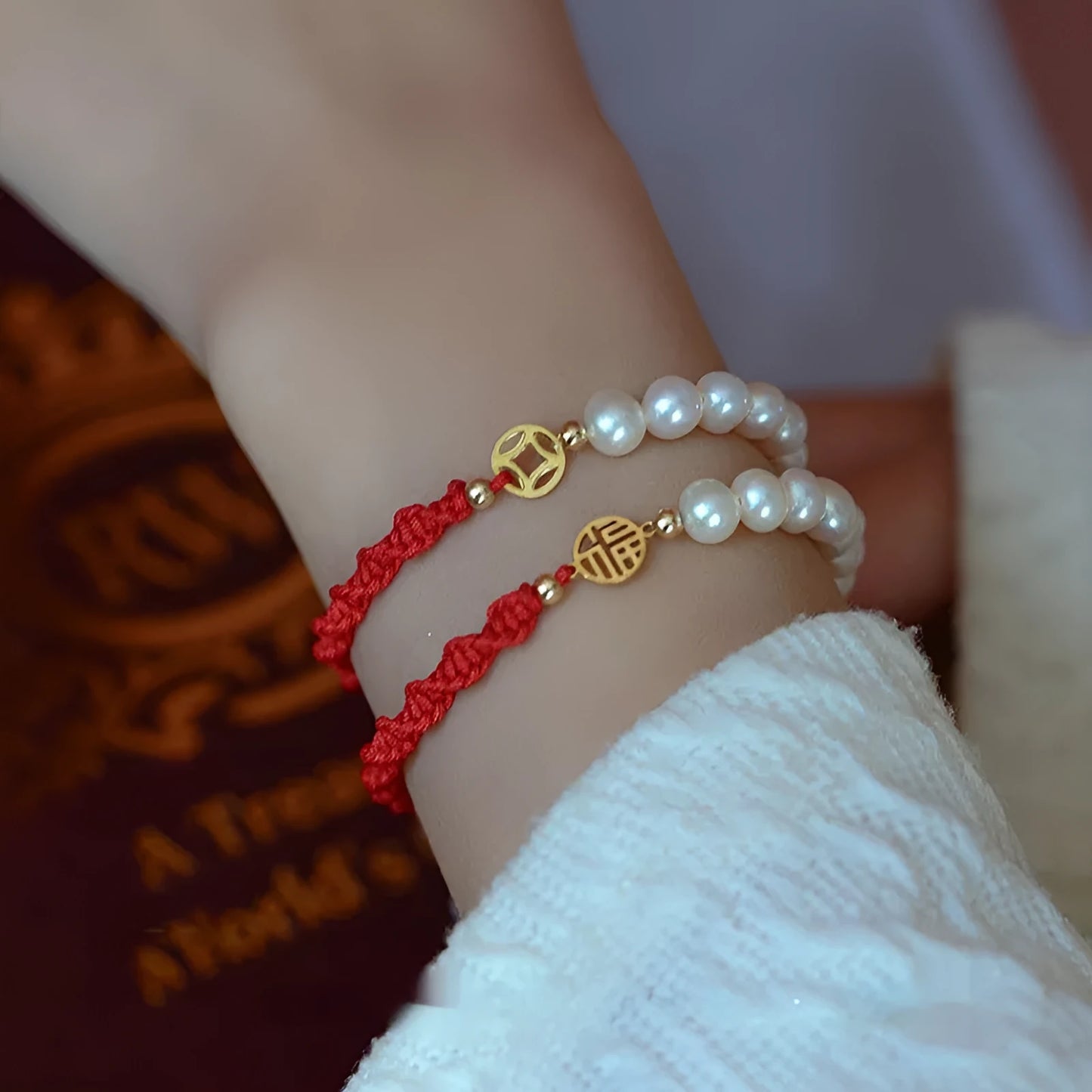 Women's pearl bracelet with braided red rope and geometric fu character charm