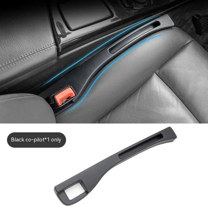 Black car seat gap storage box organiser with compartments and carrying handle between vehicle seats