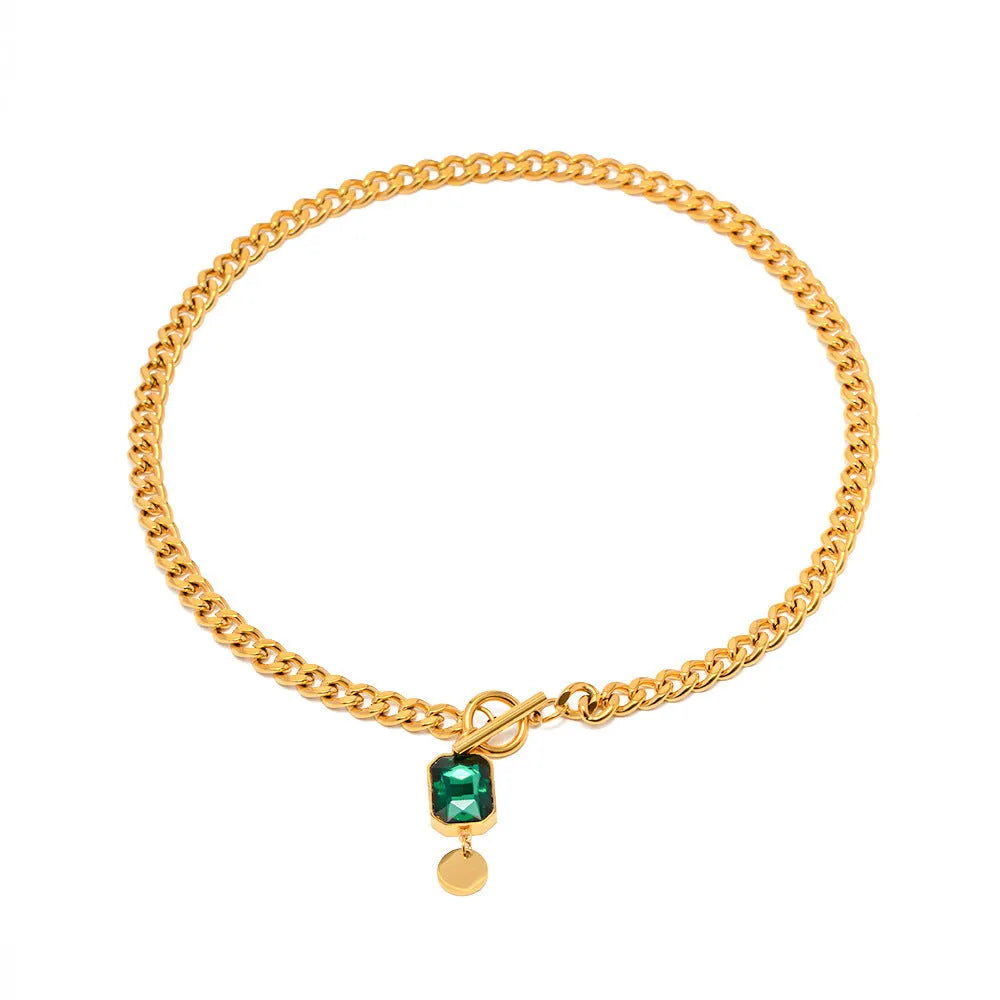 Gold geometric round pendant on a titanium steel Cuban link necklace, 50cm long.
