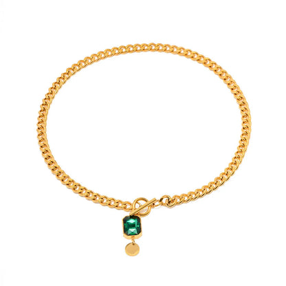 Gold geometric round pendant on a titanium steel Cuban link necklace, 50cm long.