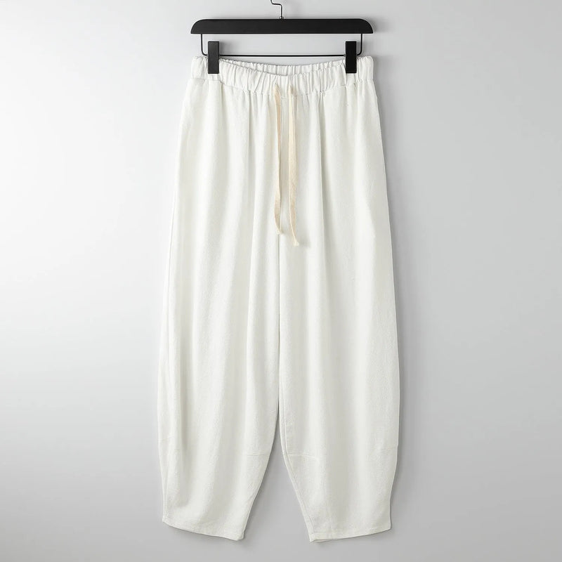 Loose harem pants with ankle ties and tapered fit made from pure linen fabric available in sizes from L to 9XL with maximum waist stretches ranging from 80cm to 173.33cm in colours including black, dark blue, gray, khaki and white for plus size comfort
