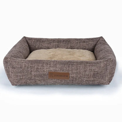 Grey linen-look square dog bed for medium-sized dogs on a wooden floor