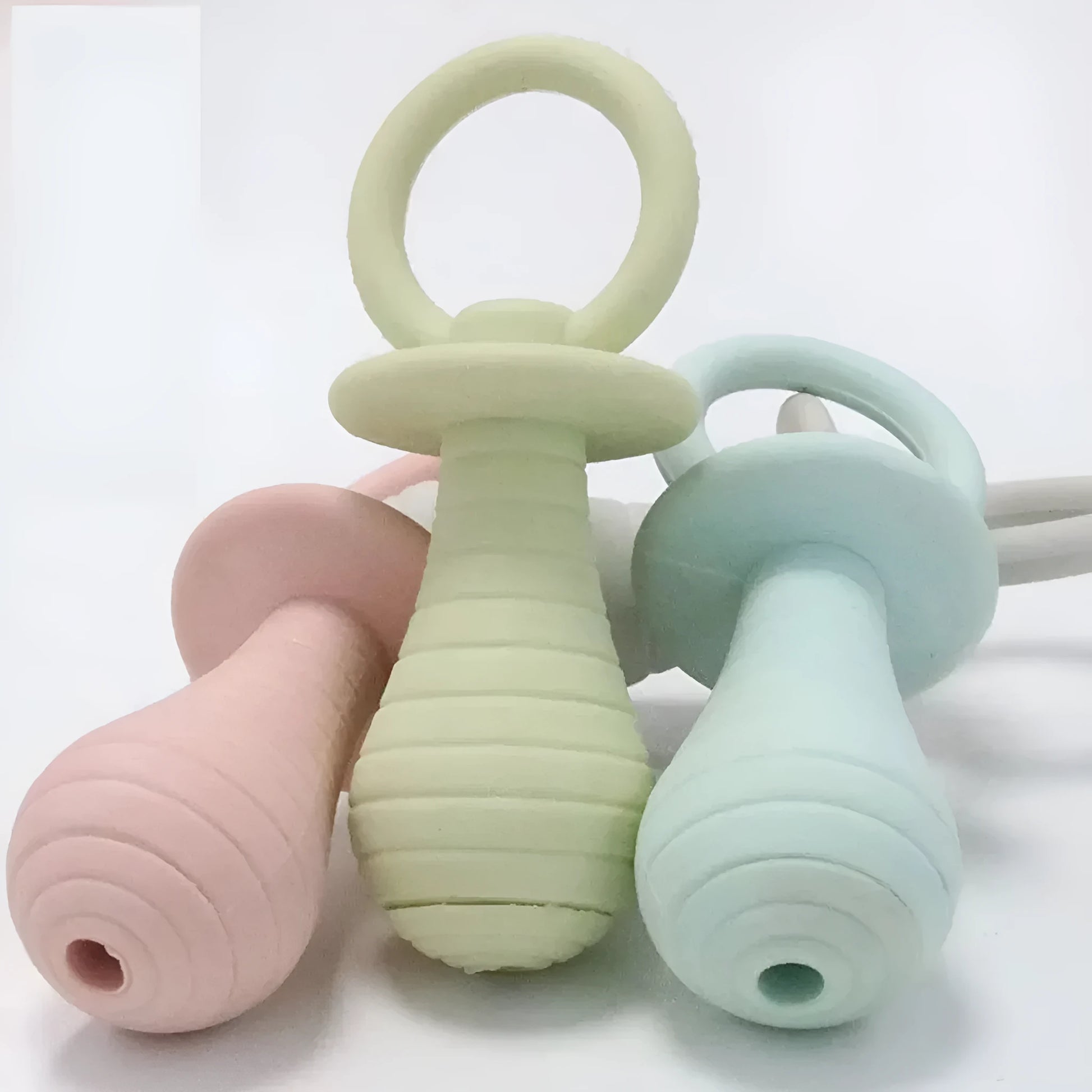 Blue TPR pet pacifier chew toy with squeaker for puppies and kittens on a white background.