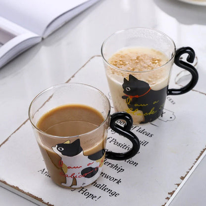 Adorable cat-themed glass mug with a whimsical cat-shaped handle, perfect for coffee, tea, and juice lovers