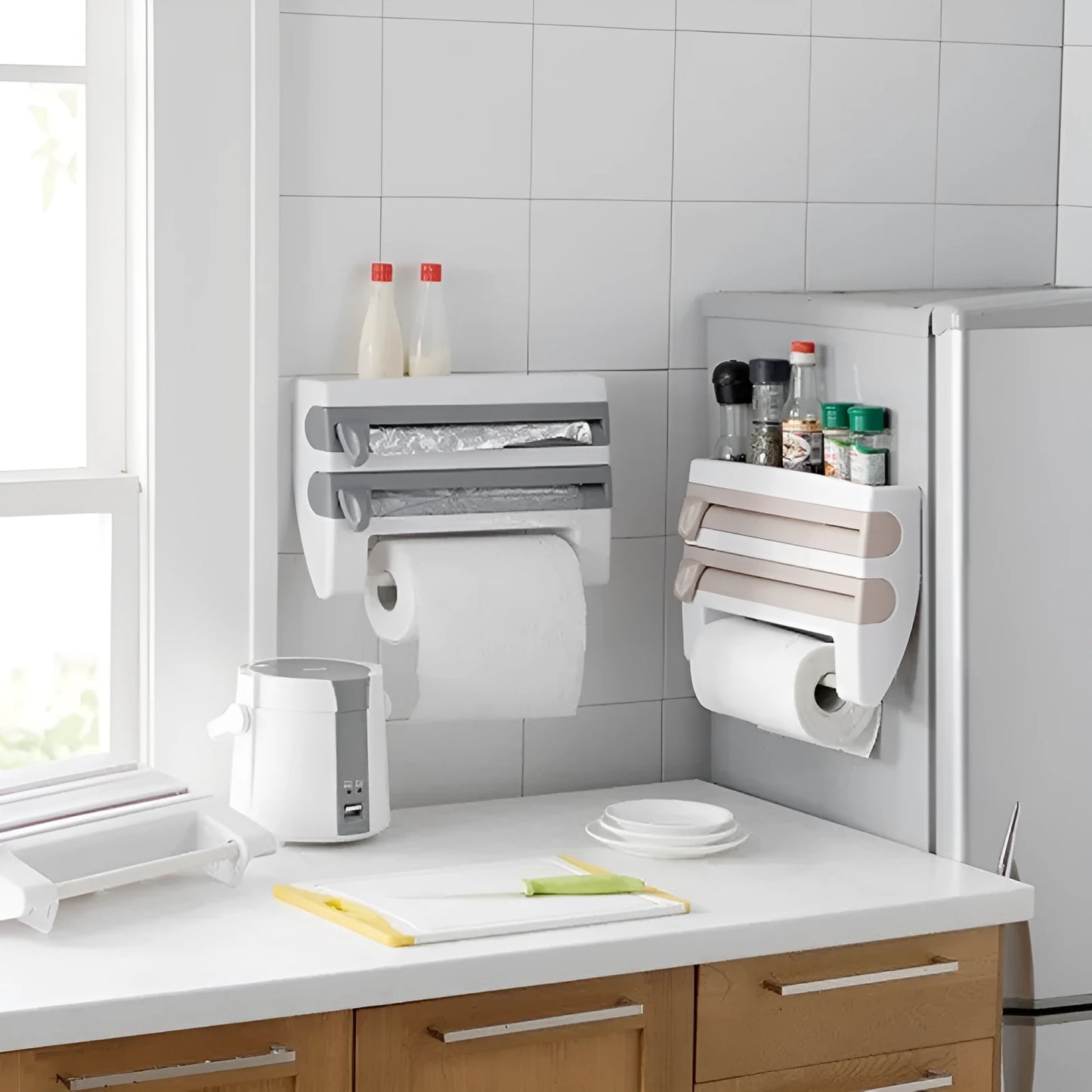 White wall-mounted kitchen roll holder dispenser for cling film, foil, and paper towels.