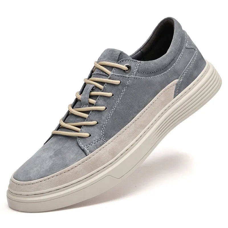 Men's grey low-top casual leather skate shoes with round toe and flat rubber sole on a neutral background.