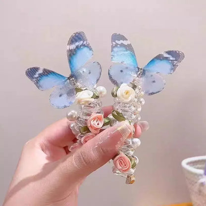 Colourful butterfly and pearl elastic hair band for children on a white background.