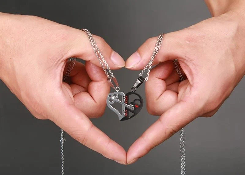 Captivating couples' love necklace set in gold, black, and silver colours with delicate chain and symbolic pendant design