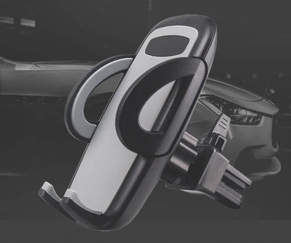 Black universal car air vent mobile phone holder attached to a vehicle vent, showing adjustable arms and 360-degree rotation.