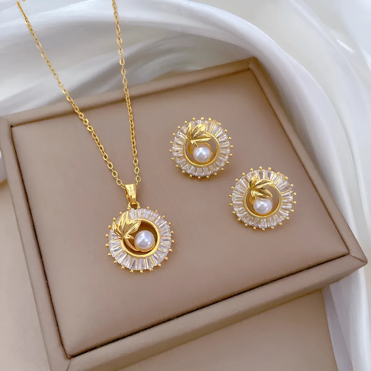 Women's geometric leaves design jewellery set with titanium steel necklace and gold plated stud earrings.