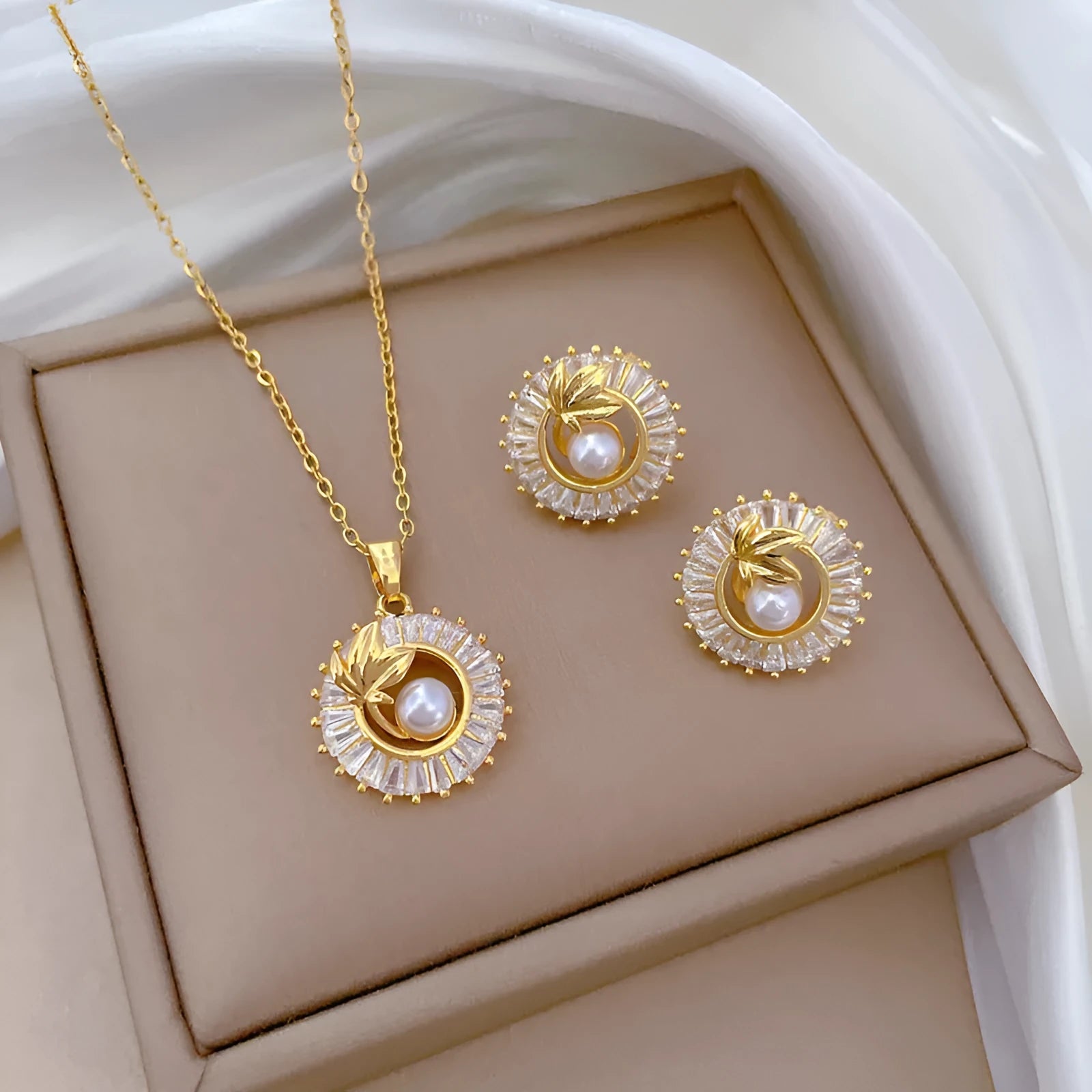 Women's geometric leaves design jewellery set with titanium steel necklace and gold plated stud earrings.