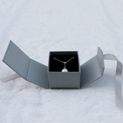 Grey square jewellery box with white ribbon bow measuring 5x5x4cm with sponge-lined interior