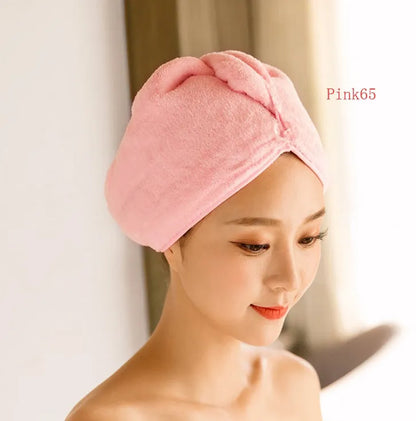 A woman wearing a sky blue microfiber hair dryer cap, with wet hair tucked inside, showing the towel's wrap-around design.