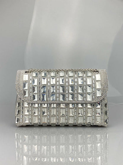 Silver rhinestone-decorated PU leather clutch bag with a metal chain strap, shown open to reveal interior phone pocket.