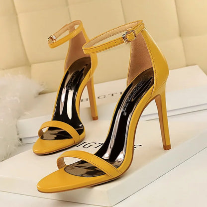 Women's open-toe high heels with an ankle strap and buckle, shown in multiple colours.