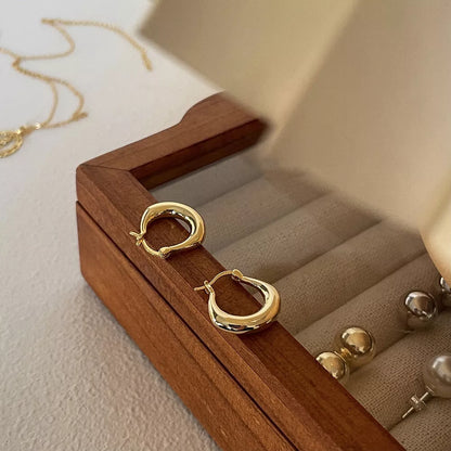 Small fat circle ear clip bracelet in white gold and yellow gold colours