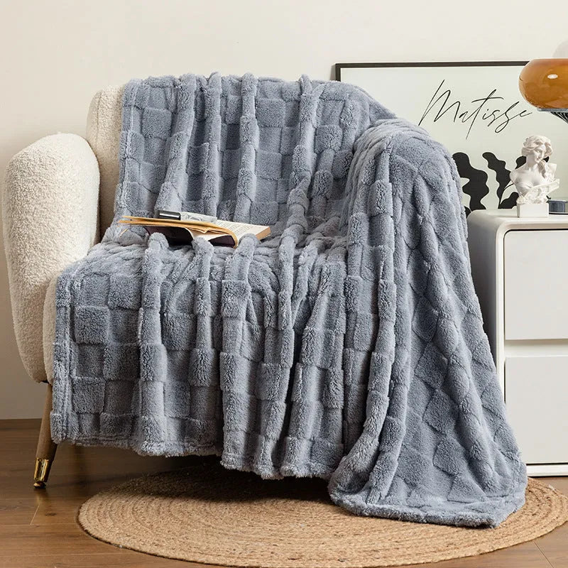 Geometric pattern polyester blanket in dark grey colour draped over sofa