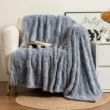 Geometric pattern polyester blanket in dark grey colour draped over sofa