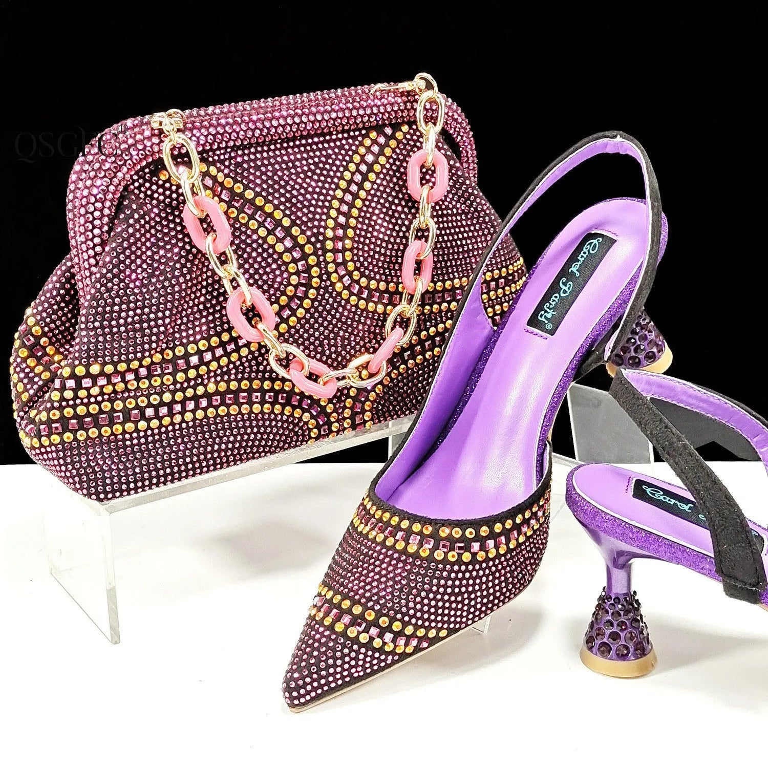 Women's pointed toe high heels with rhinestones and a matching small bag in blue.