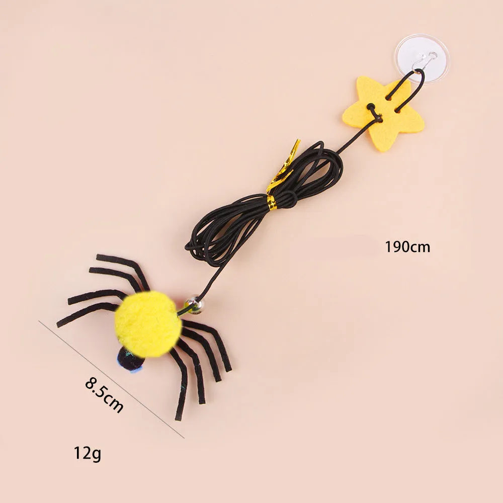 Red hanging door cat toy with elastic rope, feathers and spider-shaped bell mounted on door frame