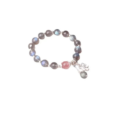 Close-up of a women's 925 silver bracelet with a 7.5mm grey moonlight strawberry stone and honeysuckle zodiac design.
