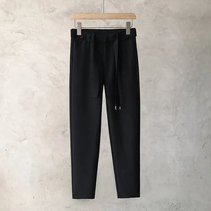 Boys slim straight wool trousers in tapered fit on hanger, showing straight leg opening.