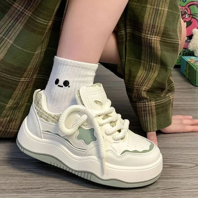 Women's green patent leather platform sneaker with round toe and lace-up closure on a rubber sole