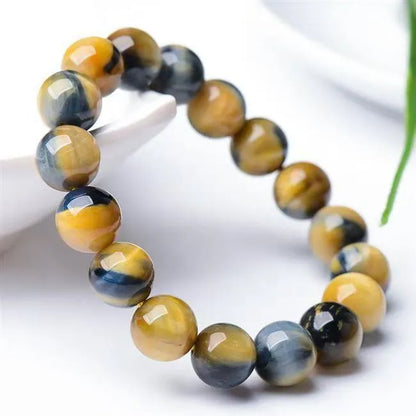 Fantasy tiger eye agate unisex bracelet with round beads in geometric single-circle design.