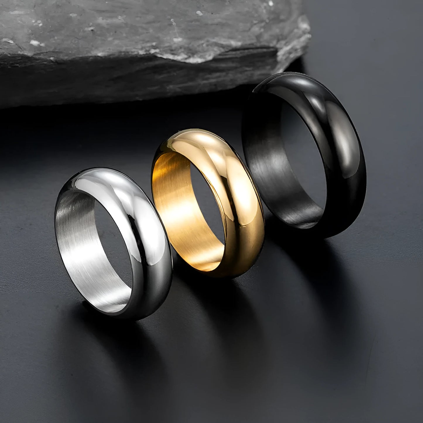 Glossy electroplated titanium steel ring in black, gold, or steel colour on finger