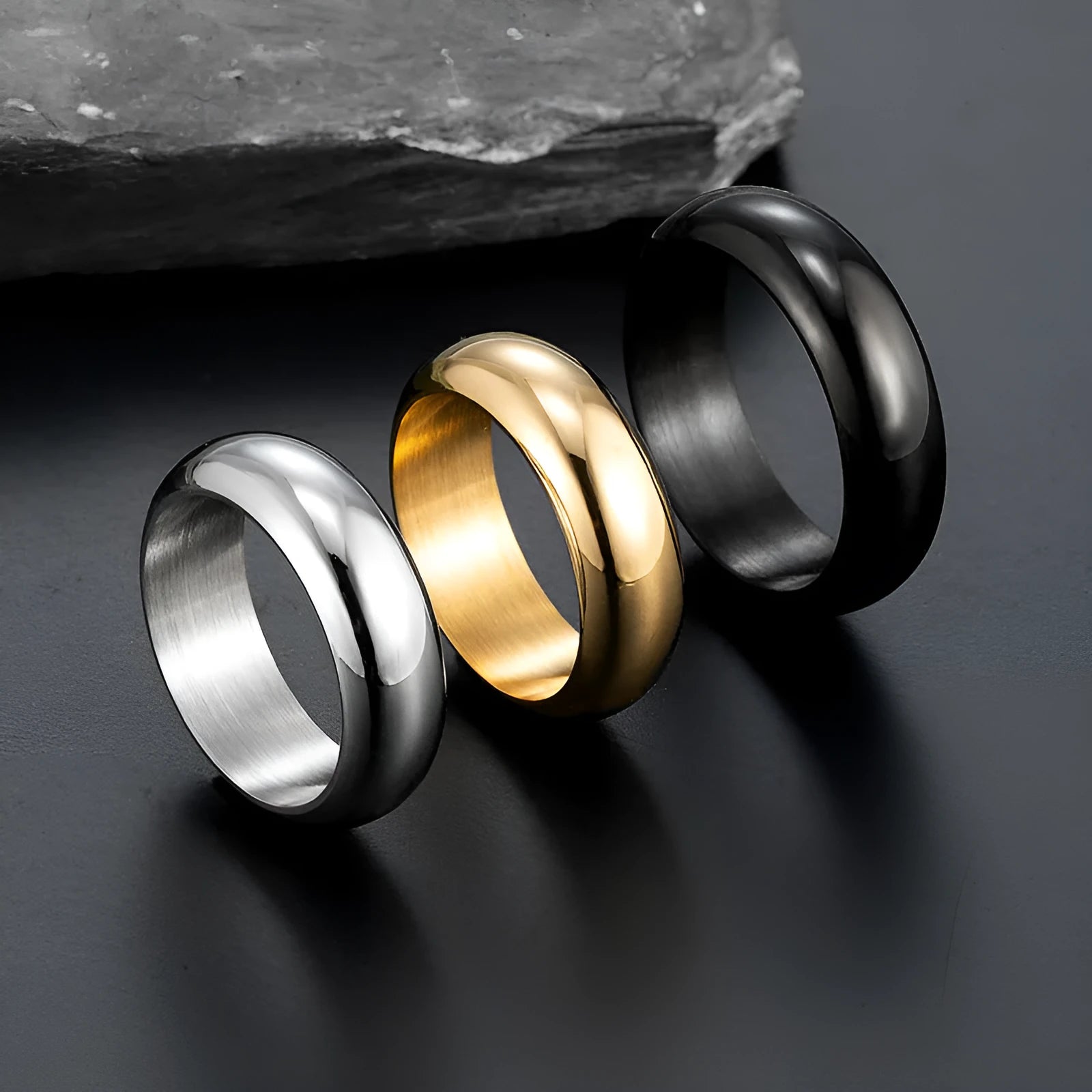 Glossy electroplated titanium steel ring in black, gold, or steel colour on finger