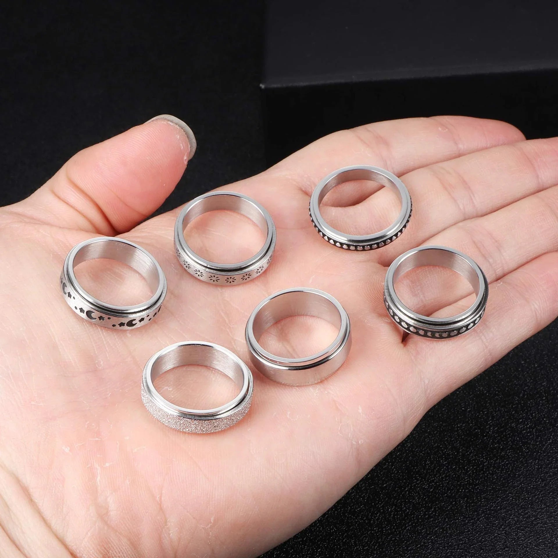 Rotatable stainless steel spinner ring with moon and star designs for anxiety relief and style