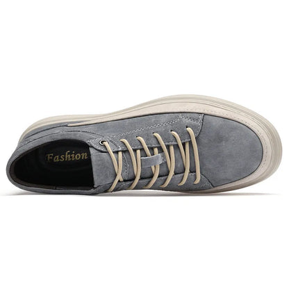 Men's grey low-top casual leather skate shoes with round toe and flat rubber sole on a plain background.
