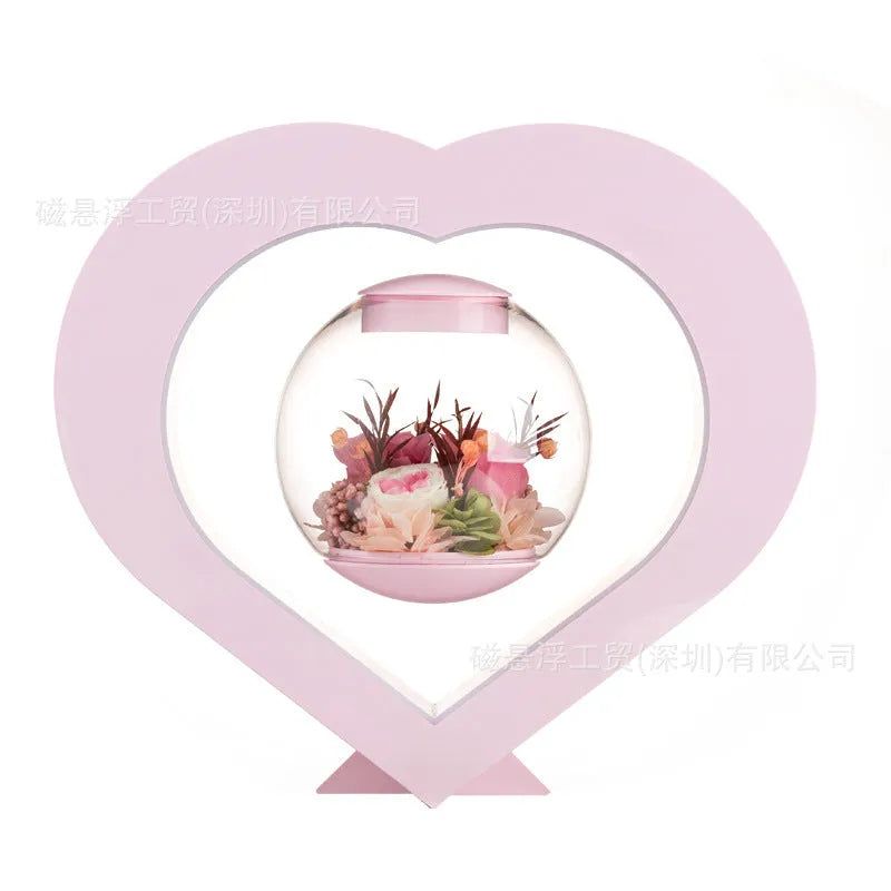 Pink preserved rose ornament with Bluetooth speaker and LED light on wooden table