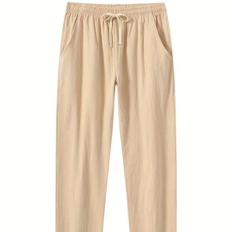 Man wearing loose-fitting cotton beach trousers in a solid colour, showcasing casual summer style.