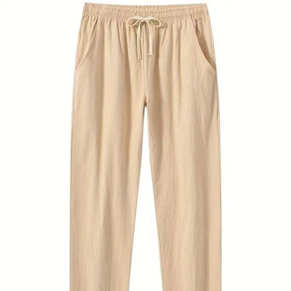 Man wearing loose-fitting cotton beach trousers in a solid colour, showcasing casual summer style.