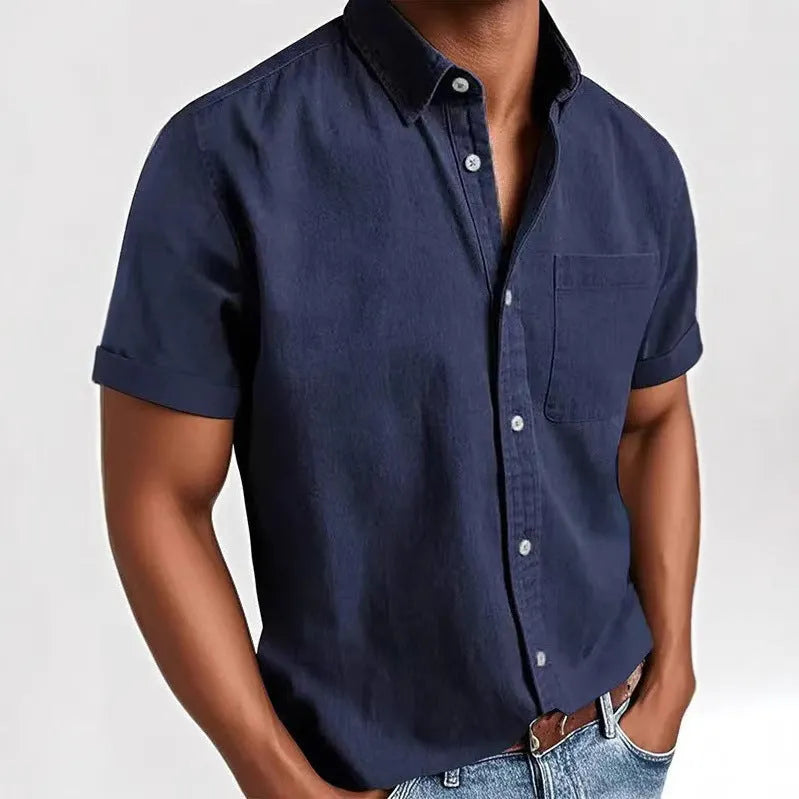 Man wearing a grey loose-fit short sleeve cardigan style shirt