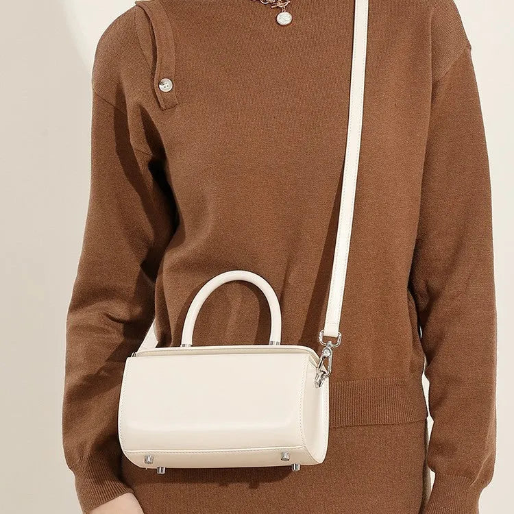 Women's leather one-shoulder crossbody bag in cowhide with clamshell design and internal phone pocket