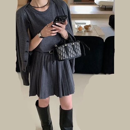 Women's grey knitted vest skirt and cardigan set with 3D pattern, adjustable belt, and pleating detail