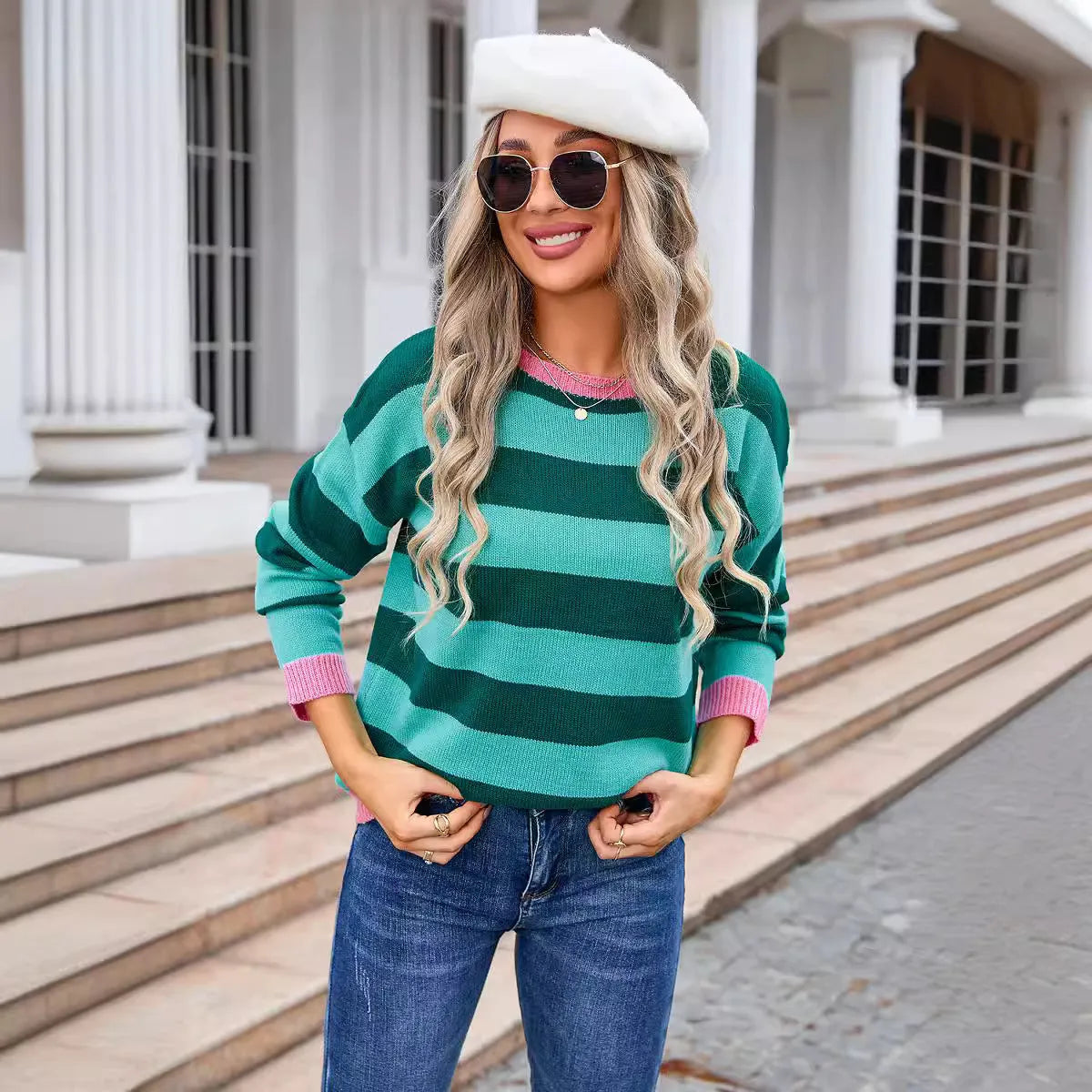 Women's loose blue striped acrylic sweater with long sleeves and round neck.