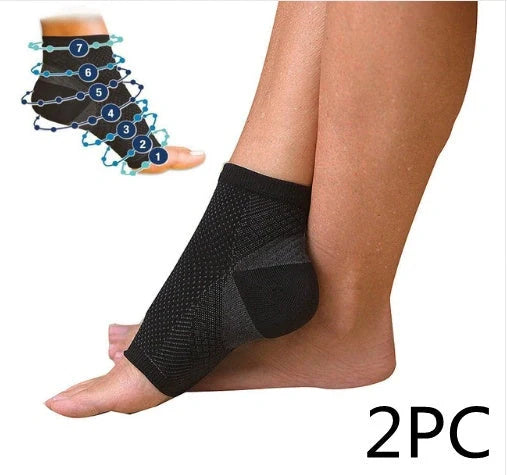 Anti-fatigue compression foot sleeve in black, red, or white, featuring moisture-wicking fabric and a heel hole for breathability.