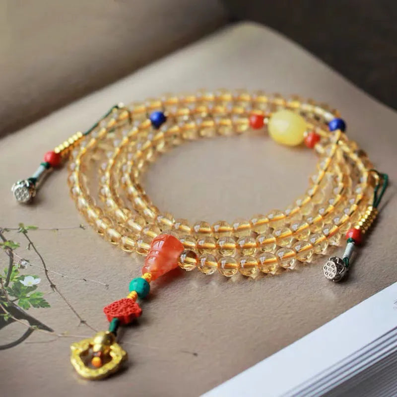 Yellow natural Brazilian citrine bracelet with 1mm beads on a gold-tone filament string.
